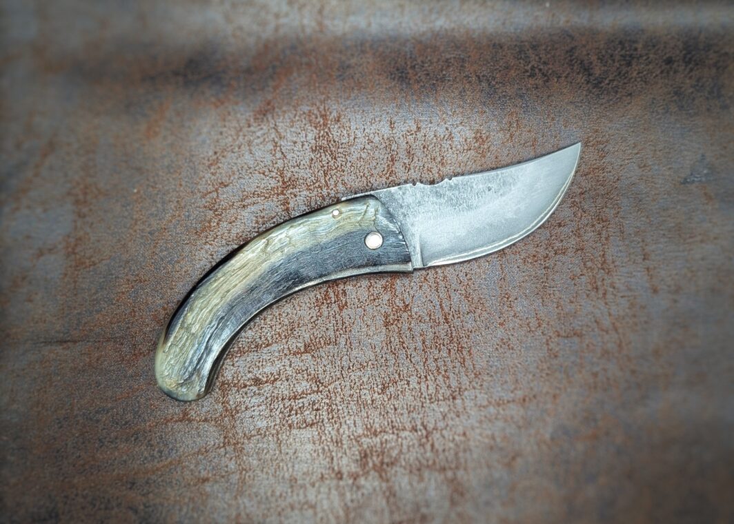 Couteau San Maï par l'artisan José Viale. Lame en San Maï. Manche en corne de bélier. Position ouverte, côté droit